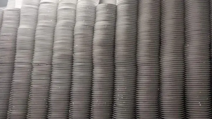 Rows of tall stacks of plaster plates